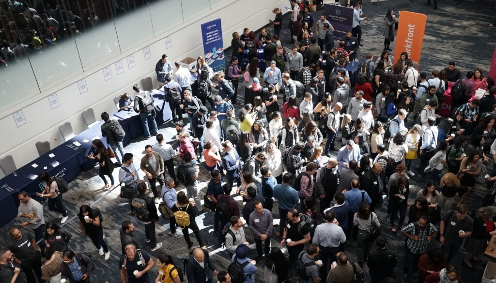 Conference Exhibition floor full of people.